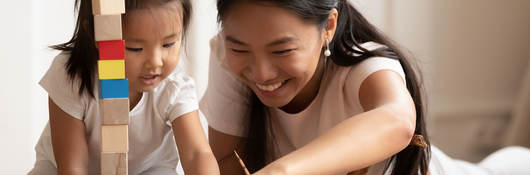 Mother and child playing with toys together